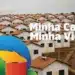 Garanta sua vaga: Inscrições abertas para o programa Minha Casa Minha Vida 2025 11 Conjunto habitacional do programa Minha Casa Minha Vida com diversas casas idênticas, destacando o logo do programa na frente.