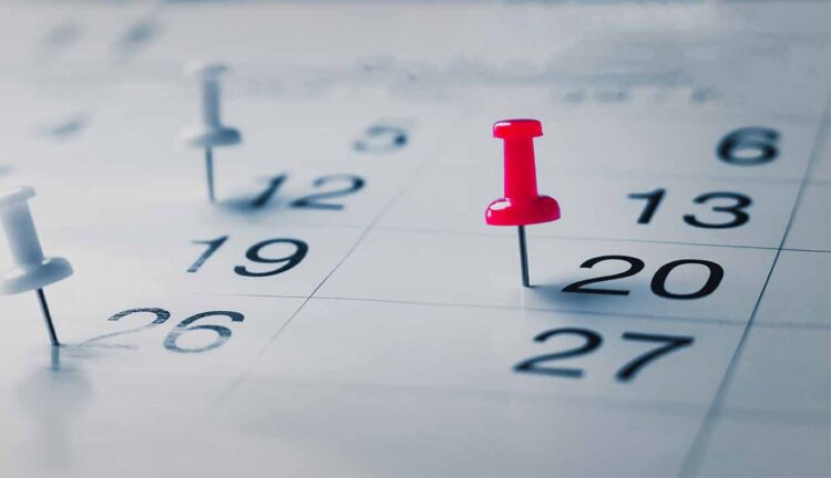 Calendário de feriados de 2026 com alfinetes marcando os dias 20 e 26 de novembro, destacando os feriados prolongados.