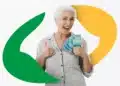 Vai ter pagamento do 13º salário do INSS nesta sexta-feira, 1º de maio? 13 Mulher idosa de cabelos brancos segura notas de R$100, fazendo sinal de positivo, com logo do INSS ao fundo.